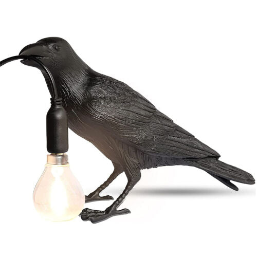 Resin raven desk lamp holding a corded LED bulb – gothic crow table light for home or office decor