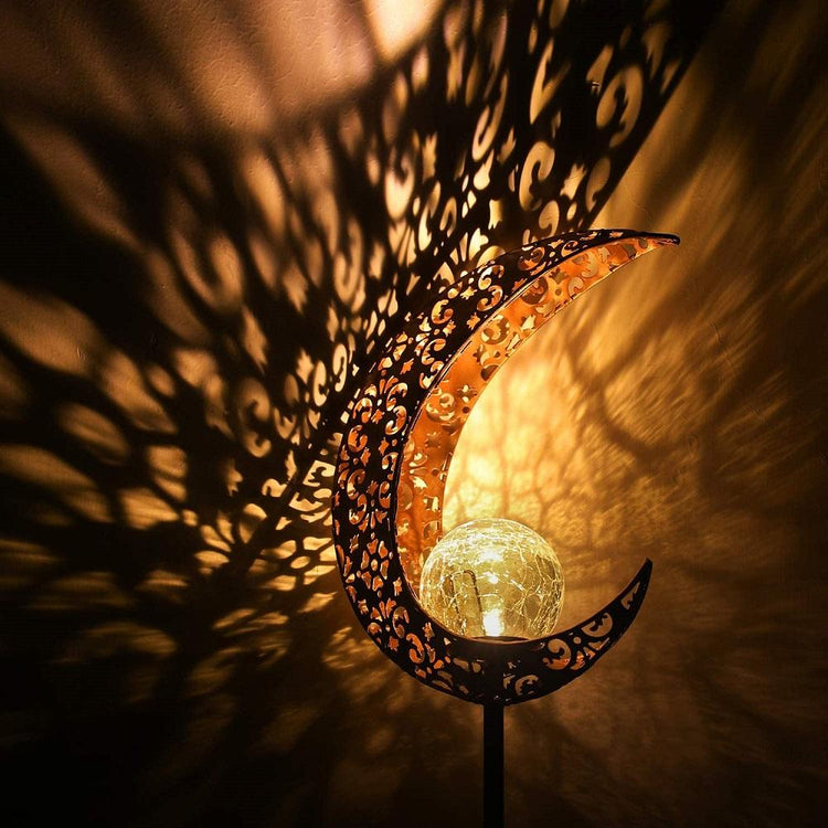 Wrought iron solar lawn light with moon design and warm LED for garden or patio use
