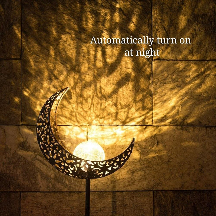 Wrought iron solar lawn light with moon design and warm LED for garden or patio use