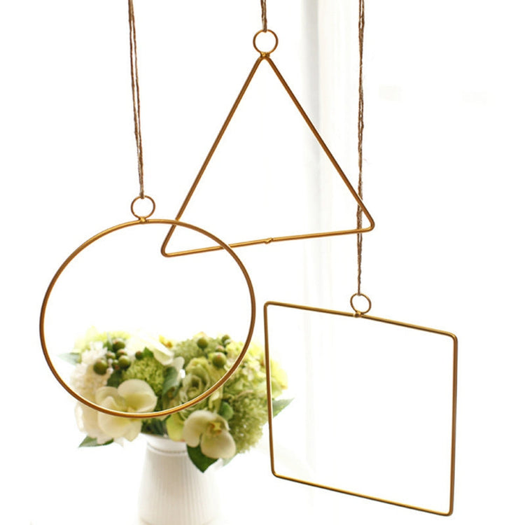 Gold geometric hanging decor made from metal, perfect for modern interiors or event styling with flowers and lights