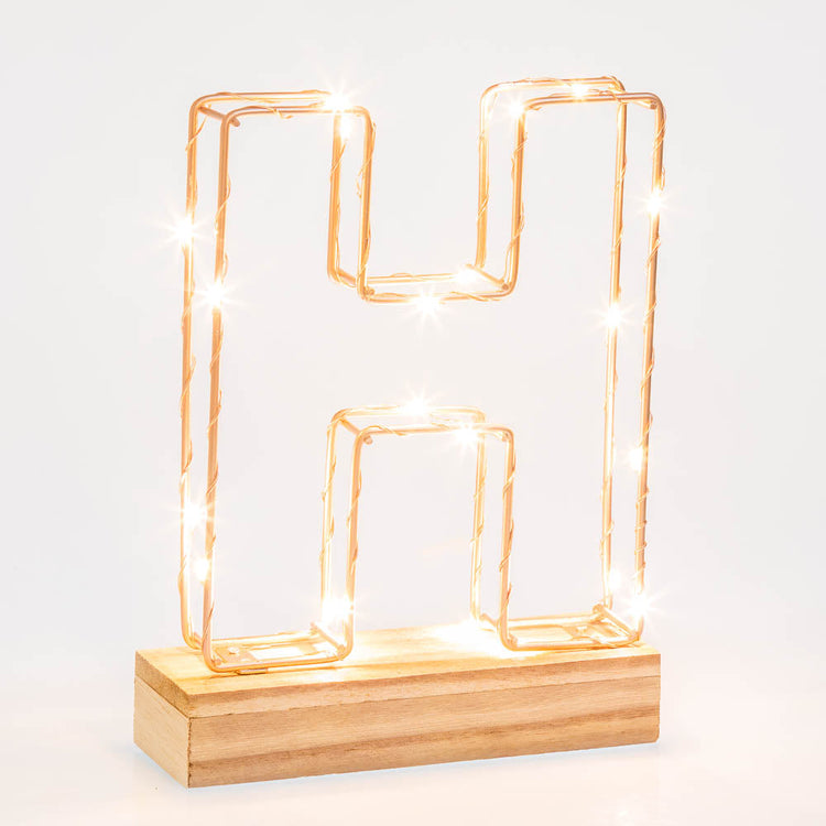 Light up letter H made from rose gold copper wire with LED lights and wooden base