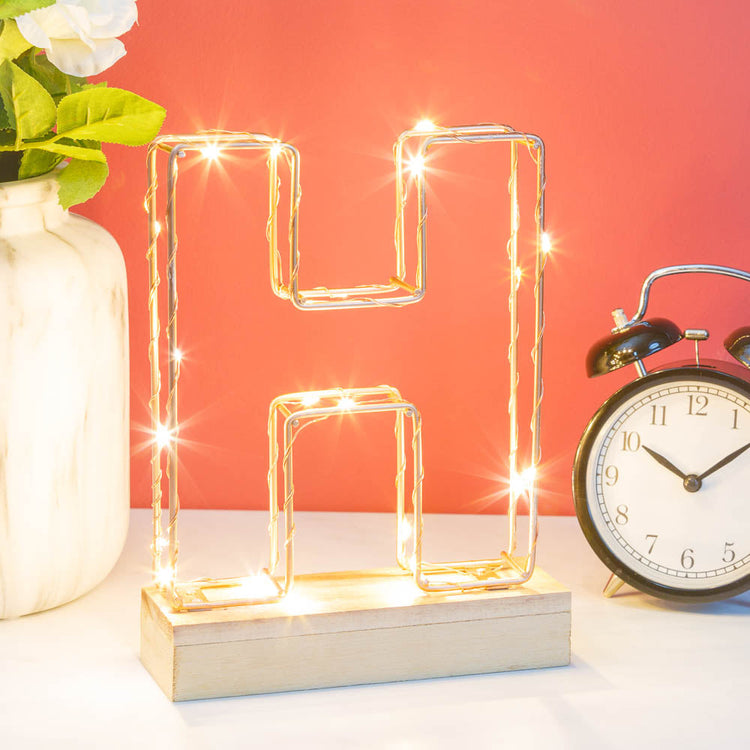 Light up letter H made from rose gold copper wire with LED lights and wooden base