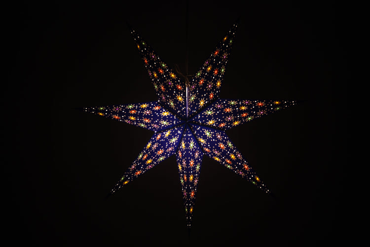 Handmade 7-pointed paper star lantern in deep blue with colorful inserts, flatpacked hanging decor