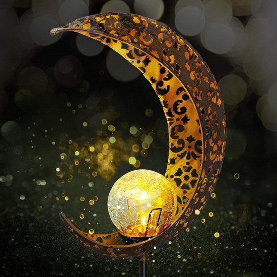 Wrought iron solar lawn light with moon design and warm LED for garden or patio use
