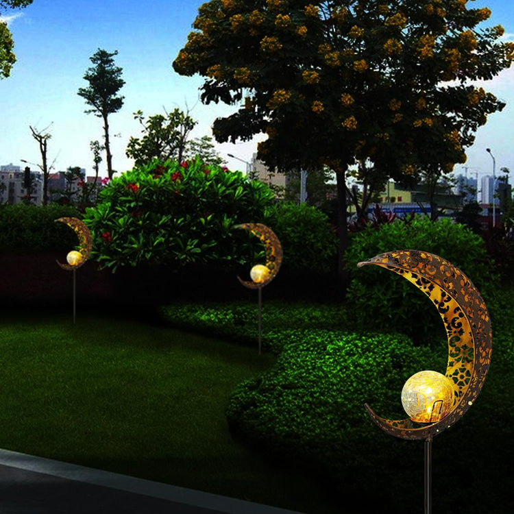 Wrought iron solar lawn light with moon design and warm LED for garden or patio use