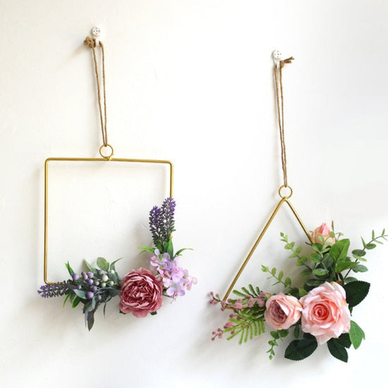 Gold geometric hanging decor made from metal, perfect for modern interiors or event styling with flowers and lights