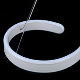 Modern LED ceiling light with swirl-shaped acrylic design and adjustable hanging wire, perfect for living rooms, dining rooms, or modern spaces