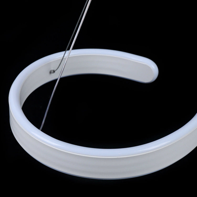 Modern LED ceiling light with swirl-shaped acrylic design and adjustable hanging wire, perfect for living rooms, dining rooms, or modern spaces
